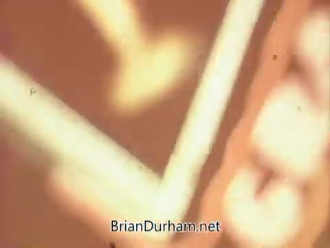 The still appears to be from a public service announcement (PSA) by the National Council on Alcoholism, produced in 1967. It features a visually abstract representation, likely emphasizing themes related to alcohol awareness and prevention. The image contains muted colors and shapes, possibly conveying a sense of urgency or concern regarding alcohol-related issues. The overall aesthetic may reflect the art style and film techniques of that era.