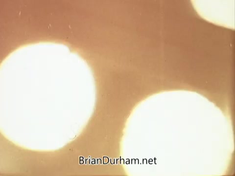 The still from the 1967 National Council on Alcoholism PSA features abstract, blurred light orbs against a softly lit background. The image evokes a sense of haziness, possibly reflecting themes of confusion or distortion associated with alcohol use. The simplicity of the composition allows for viewers to interpret the visuals in relation to the message of the PSA.