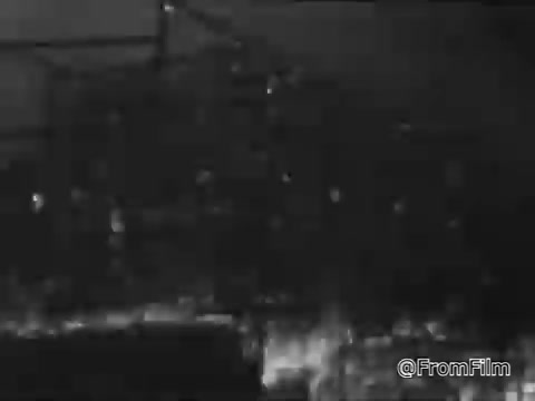 The still from the AETNA home fire safety PSA, produced in the 1960s, likely depicts a dramatic scene highlighting the dangers of fire. The image may show flames and smoke, underscoring the destructive power of uncontrolled fire. In the context of the voiceover, which conveys a serious message about the loss of homes and lives due to fire, the visual aims to evoke concern and prompt viewers to consider fire safety seriously. The overall tone is somber and urgent, stressing the importance of preparedness and prevention.