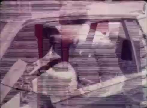 The still from the 16mm commercial shows a person entering a vehicle, likely conveying a sense of readiness or transition. The scene is part of a public service announcement promoting Job Service, encouraging viewers to utilize their services for filling job openings. The visual quality is indicative of a vintage film print, capturing a moment of everyday life related to employment. The overall tone suggests a practical and supportive approach to job placement.