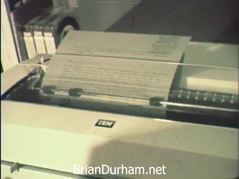The still captures a close-up of an IBM typewriter actively typing a document. The focus on the typewriter emphasizes the administrative work being done by the secretaries at Hemisfair '68. This scene reflects the duality of their roles: managing correspondence while being surrounded by the vibrant atmosphere of the world's fair, highlighting their commitment to office duties amidst enticing distractions.