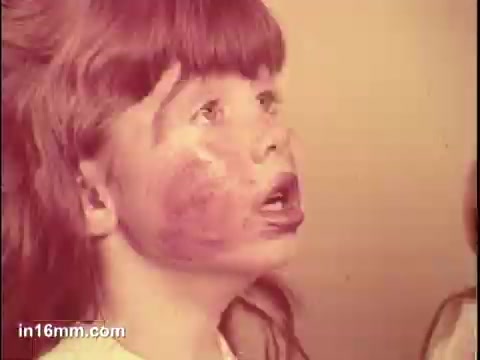 The still from the 'Puffs Tissues' commercial features a child with a distressed expression, showing signs of having a runny nose, likely highlighting the product's intended use for cold or allergy relief. The background is simple, emphasizing the child's face. The overall tone is somewhat humorous, illustrating the need for tissues in a relatable way.