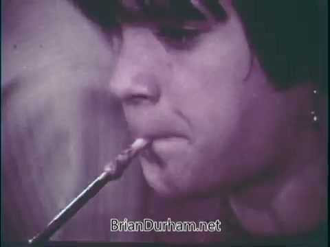 The still from 'Support Music In Your School - PSA' features a close-up of a young person playing a musical instrument, likely a woodwind. The focus is on their expression and the instrument, highlighting the importance of music education. The image conveys a sense of dedication and enthusiasm for music, encouraging viewers to support music programs in schools.