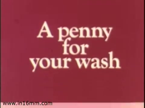 The still features a simple text graphic reading 'A penny for your wash' against a reddish background. This suggests a nostalgic, perhaps promotional context highlighting economical practices related to gas usage for household functions, typical of advertising aiming to emphasize savings and efficiency. The 16mm film format conveys a vintage aesthetic, aligning with the era before the company's rebranding to Enserch in 1975.