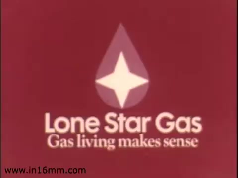 The still features the logo of Lone Star Gas, prominently displaying a stylized drop shape with a white star in the center, against a solid red background. The slogan 'Gas living makes sense' is featured below the logo in a bold, simple font. This visual emphasizes the company's branding and its message promoting the benefits of natural gas in everyday living before the company rebranded to Enserch in 1975.