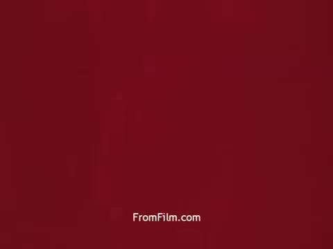 The still from 'Bayer Works Wonders' features a solid, rich red backdrop. This color choice likely evokes warmth and vibrancy, aligning with the promotional intent of the piece from the early 1970s. The simplicity of the image suggests a focus on branding or a striking visual impact, typical for advertising materials of that era.