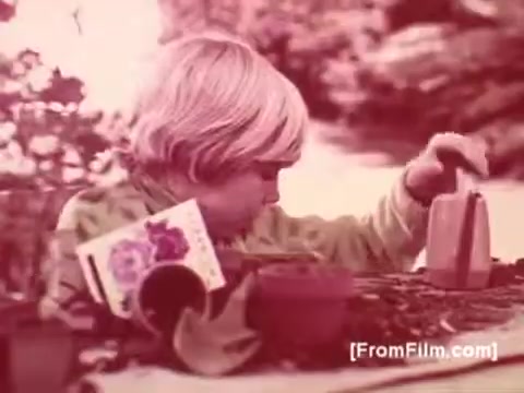 The still from the PSA features a young child focused intently on a small gardening project. The scene is bathed in a soft, warm hue, typical of 16mm film prints. Various gardening tools and pots are visible, suggesting a nurturing environment. This imagery is likely intended to evoke a sense of care and hope, aligning with the message of the Muscular Dystrophy Association. Joan Crawford's voice-over would provide a poignant narrative, emphasizing the importance of support for those affected by muscular dystrophy.