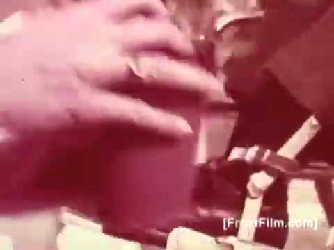 The still features a close-up of a hand gripping a cup, possibly indicating a personal moment or gesture related to care. The muted color palette suggests a vintage aesthetic typical of 16mm film stock. This visual aligns with the emotional and informative tone typically found in public service announcements, especially those addressing conditions like muscular dystrophy, possibly reinforced by a voice-over from Joan Crawford emphasizing support and awareness for the cause.