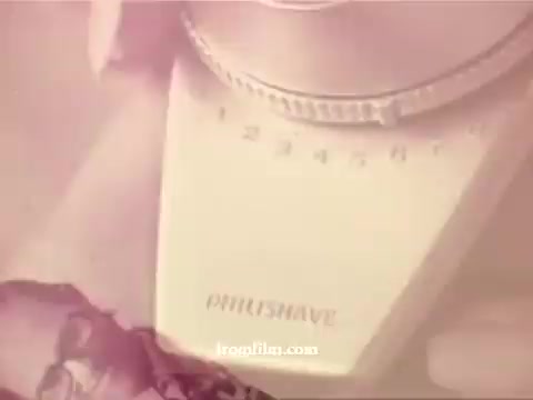 The still from 'Philishave: Xmas (Brazilian)' depicts a close-up of a Philishave electric shaver, prominently displaying its brand name. The 1970s aesthetic is evident, with a vintage design and a muted color tone. The focus on the shaver suggests a connection between personal grooming and holiday themes, enhancing the festive context of the advertisement.