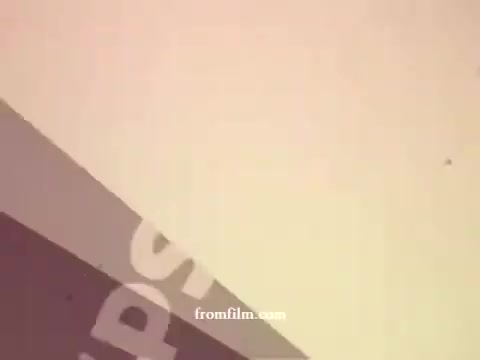 The still from 'Philishave: Xmas (Brazilian)' features a minimalistic design typical of 1970s graphics. It displays a gradient background with soft, muted colors. Prominent text elements, likely advertising or branding, are arranged dynamically, hinting at the promotional nature of the content. The overall aesthetic is retro, reflective of the era's visual style.