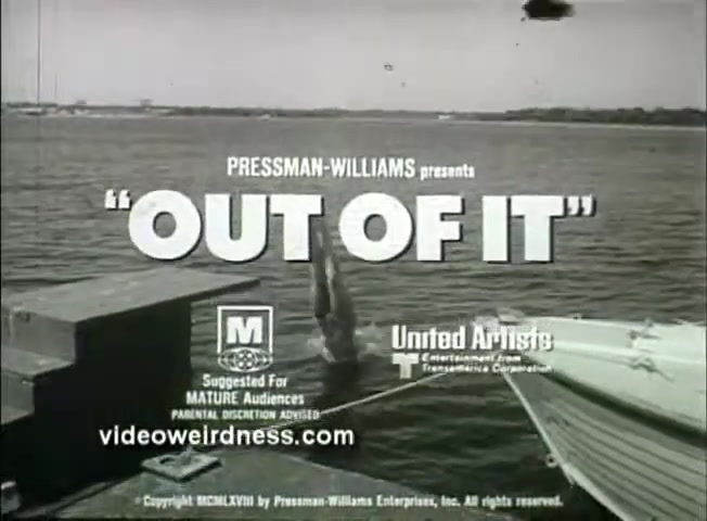 The still from the trailer for 'Out of It' (1969) features a man diving into water from a wooden dock. The background showcases a body of water, setting a tranquil yet adventurous scene. The title 'OUT OF IT' is prominently displayed, along with the 'M' rating for mature audiences and the logos for Pressman-Williams and United Artists. The overall tone hints at a coming-of-age or dramatic narrative.