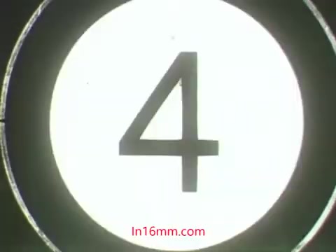 The still features a large, stark number '4' against a bright, circular background, reminiscent of a film countdown. This visual element suggests a moment of anticipation or a transition in the film. The context provided points to a comedic and educational scenario involving puppets Ollie and Kukla discussing the unintended consequences of using pesticides on plants, highlighting the importance of proper care and caution. The whimsical tone of the dialogue reflects the 1960s style of public service announcements aimed at educating viewers through humor and character interaction.