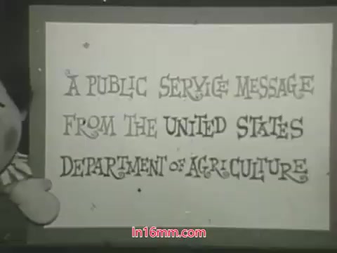 The still features puppets from the 1960s public service announcement by the USDA. Ollie is shown expressing distress over his dead plant, which he mistakenly treated with a pesticide he refers to as a 'bug bomb.' Kukla responds with concern, highlighting the consequences of improper pesticide use. The message emphasizes responsible pesticide application. The background includes a sign reading, “A Public Service Message from the United States Department of Agriculture,” highlighting the educational intent of the PSA.