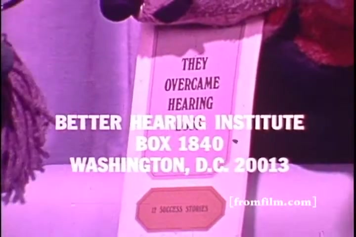 The still features a prominent title, 'THEY OVERCAME HEARING,' indicating a focus on personal success stories related to hearing challenges. Below the title, the logo and address of the Better Hearing Institute are displayed. The overall aesthetic reflects the 1970s style, common in public service announcements, and emphasizes a message of overcoming hearing difficulties.