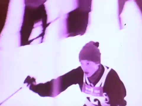 The still from the 'Mobil I' oil commercial features a skier in motion on a snowy slope. The skier, wearing a beanie and an athletic outfit, appears focused and determined. The image has a washed-out, muted color palette, giving it a vintage feel indicative of 16mm film. The context suggests a theme of performance and reliability in challenging conditions, likely highlighting the benefits of Mobil I oil.