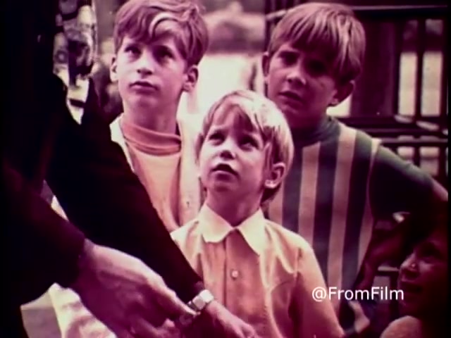 The still from the 1970 PSA 'Why do you think they call it dope?' features a group of children, looking intently at an adult figure. Their expressions convey curiosity and concern, highlighting a serious conversation about the dangers of drug use. The warm color tones typical of 16mm film give it a nostalgic feel, while the children's focused demeanor underscores the PSA's message aimed at educating youth about anti-drug sentiments.