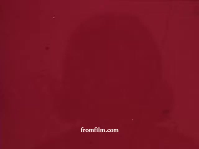 The still features a blurred silhouette against a deep red background, likely indicative of a vintage commercial for Formula 44. The lack of clear details suggests a dreamy or nostalgic quality, typical of older advertisements.