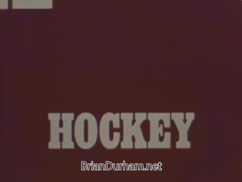 The still features a bold, prominently displayed word 'HOCKEY' in a retro font, set against a deep reddish background. The design captures a vintage aesthetic typical of early 1970s television promotions. The overall look conveys a sense of energy and excitement related to the sport.
