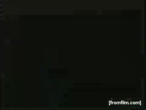 The still from the 'Movietone Battle Of Britain' newsreel likely depicts a historical moment from World War II, focusing on the events of the Battle of Britain. It features Lowell Thomas, a prominent broadcaster of the time, delivering commentary or reporting on the aerial conflict. The visual quality, typical of 16mm film, may show graininess and muted colors, emphasizing the documentary style of the era. The context suggests a mix of dramatic imagery and wartime updates intended to inform and engage viewers.