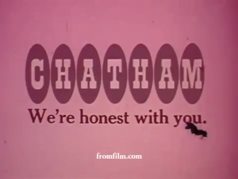 The still from the 'Chatham Supermarket Commercials' features the store's logo prominently displayed against a pink background. The branding emphasizes honesty with the tagline “We’re honest with you.” The context suggests a focus on various supermarket items such as apples, bananas, meats, potatoes, and steak, likely highlighting deals or promotions through imagery of products and shopping carts. The visual style reflects the vintage aesthetic of 16mm film prints.