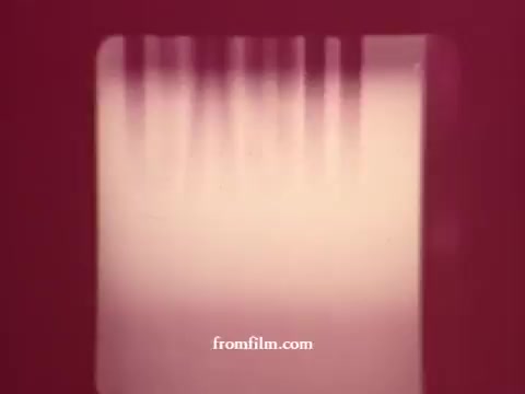 The still from 'Chatham Supermarket Commercials' features a blurred, unrecognizable image with a reddish hue. It might be a transition or title card related to the various products advertised, such as apples, bananas, fresh meats, and potatoes. The focus is on promoting the supermarket's offerings, likely emphasizing freshness and value through comparative visuals or coupons. The quality suggests it's sourced from 16mm film, capturing an era of vintage advertising.