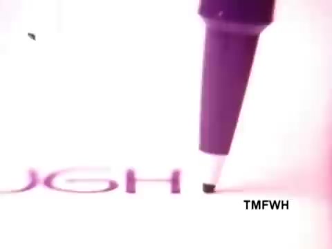 The still features a close-up of a Flair pen poised over paper, focused on the moment it makes contact as it writes the word 'TOUGH.' The background is softly illuminated, enhancing the pen's sleek design and emphasizing its writing capability.