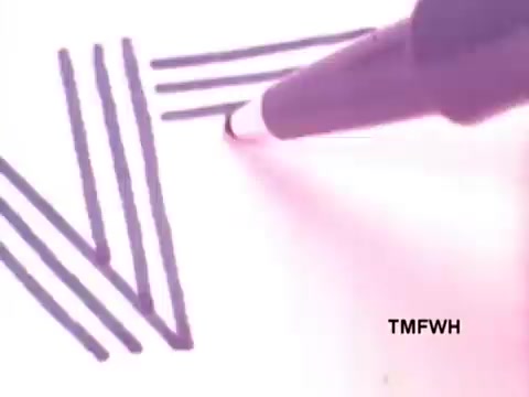 The still from the Flair Pen commercial features a close-up of a pen drawing straight, parallel lines on a white surface. The focus is on the pen's tip and the ink's smooth flow, emphasizing the pen's precision and writing quality. The visual conveys a sense of creativity and ease in writing.