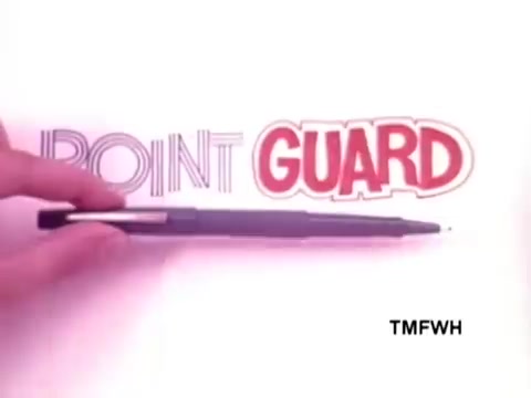 The still showcases a hand holding a Flair pen, positioned next to the word 'POINT GUARD,' which is styled prominently in bold red letters. The focus is on the pen's design, emphasizing its features and quality. The background is minimalistic, enhancing the visual appeal of the pen and text.