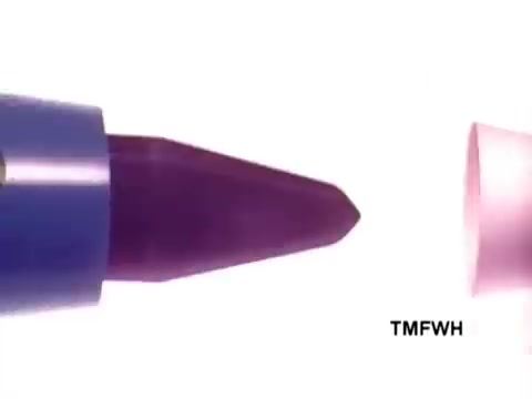 The still from the Flair Pen commercial features a close-up of a marker or pen with a blue body and a purple tip. The cap, which is pink, is slightly detached, emphasizing the pen's design. The background is plain white, highlighting the pen's features and colors, suggesting a focus on ease of use and functionality. The frame indicates a playful and vibrant appeal typical of promotional materials.