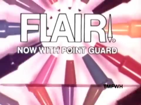 The still features the logo 'FLAIR!' prominently at the center, surrounded by vibrant, colorful pens radiating outward. The text 'NOW WITH POINT GUARD' emphasizes a new feature, highlighted by dynamic graphics. The overall design conveys energy and excitement, typical of a product advertisement.