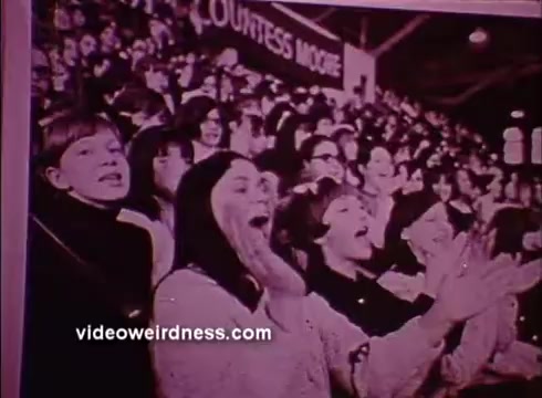 The still from the 'Hearing PSA' features a lively crowd at an event, with several individuals showing excitement and engagement, likely encouraging awareness about hearing health. The atmosphere appears dynamic, highlighting the importance of communication and sound, relevant to the message of the Better Hearing Institute.