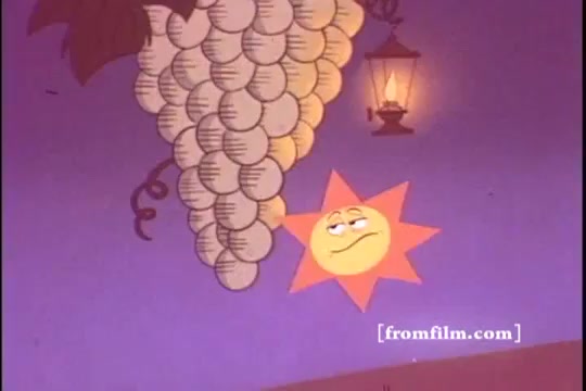 The still features a cartoonish sun character with a playful expression, positioned beneath a cluster of stylized grapes. The background is a soft purple, enhancing the whimsical atmosphere. A lantern hangs nearby, adding a cozy touch. This imagery aligns with the promotional themes of Kellogg's Raisin Bran, emphasizing natural ingredients and a cheerful start to breakfast.
