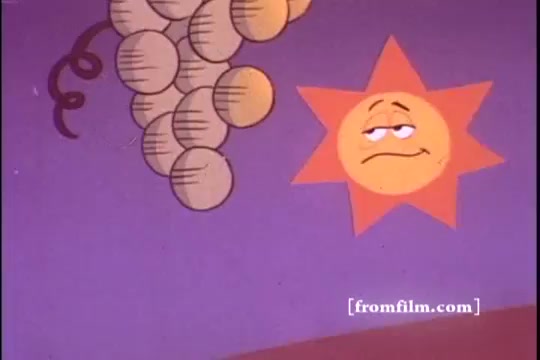 The still features a cheerful, animated sun character and a cluster of grapes against a colorful, purple background. The sun has a playful expression, likely conveying joy or excitement about the product, while the grapes suggest the natural ingredients used in Kellogg's Raisin Bran. The bright colors and whimsical design are characteristic of 1970s animated commercials, aiming to appeal to families and children.
