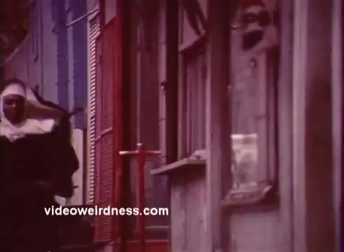 The still from 'Come Back, Charleston Blue' features a nun walking past colorful storefronts, capturing the vibrant street life depicted in blaxploitation films. This scene reflects the film’s setting and themes, showcasing the cultural richness and social issues of the time. The film, a sequel to 'Cotton Comes to Harlem,' continues the story of detectives Coffin Ed Johnson and Gravedigger Jones, who navigate the complexities of crime and community in Harlem.