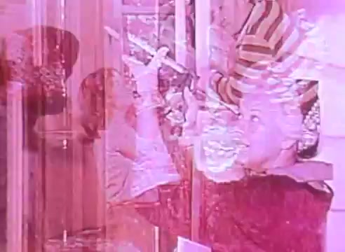 The still from 'Welcome to Fulton St - energy efficient houses PSA 2' features a vibrant, multicolored overlay that suggests a warm, nostalgic atmosphere. It captures children engaged with their surroundings, indicating a focus on family and community. The imagery hints at themes of sustainability and energy efficiency, likely promoting positive messages about home life in energy-conscious households. The visual style, with its soft hues, evokes a sense of comfort and optimism.