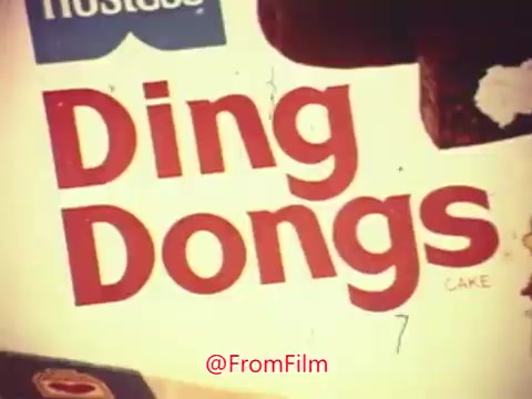 The still features the packaging of Hostess Ding Dongs, with the brand name prominently displayed at the top. The word 'Ding Dongs' is large and bold, accentuated by playful colors. Below it, the word 'CAKE' is included, emphasizing the dessert's nature. The overall aesthetics suggest a retro commercial vibe, likely appealing to nostalgic viewers.