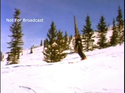 The still shows a skier navigating down a snowy slope, surrounded by evergreen trees under a clear blue sky. The scene conveys a sense of winter recreation and natural beauty, typical of outdoor public service announcements promoting environmental awareness. The text overlay 'Not For Broadcast' indicates that this image is intended for internal use only.