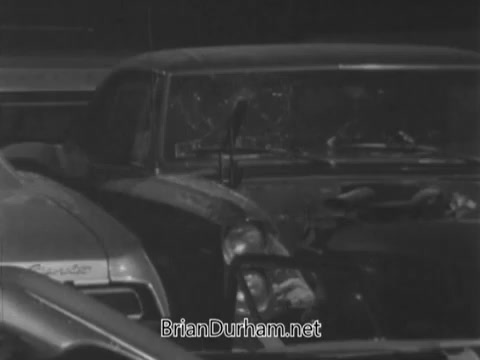 The still depicts a damaged car, showcasing significant wear and tear. It likely illustrates the theme of the PSA, emphasizing the idea of providing insurance that revitalizes cars while hinting at the importance of personal safety and well-being. The visual contrast between the car's destruction and the message about life insurance underscores the dual focus on vehicles and personal protection in the context of accidents.