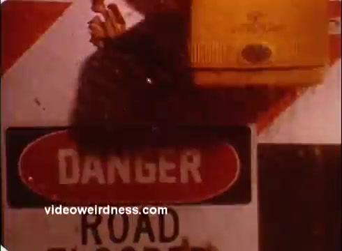 The still from the 'Red Cross PSA' features a road sign prominently displaying the word 'DANGER' alongside a 'ROAD CLOSED' message. The background is a mixture of construction barriers, emphasizing the urgent warning. The overall tone suggests a focus on safety and awareness, typical for public service announcements.