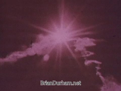 The still features a bright, sunlit sky with rays of light radiating from a central point, surrounded by wispy clouds. The overall tone is warm, with pink and soft white hues, setting a vibrant and uplifting mood. This visual aligns with the advertising message of Dove, emphasizing freshness and the benefits of their cream-infused formula in contrasting with traditional soap.