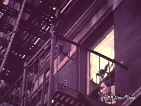The still from the 'Job Corps PSA - 1960s' captures a moment where a young person is seen looking out from a fire escape. The scene reflects themes of urban life and possibly feelings of aimlessness, aligning with the lyrics questioning the meaning of waking up with nothing to do. This visual element underscores the PSA's message about the importance of opportunity and engagement, particularly in the context of job training and youth programs during that era.