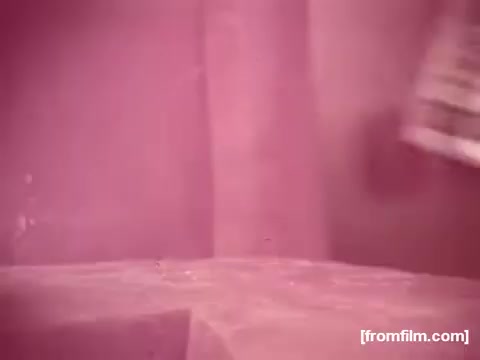 The still from the 'Borden American Cheese' commercial features prominent red fading, characteristic of early 1970s 16mm film degradation. The scene likely has a focus on the cheese product, though details appear muted due to the faded color. The overall aesthetic suggests a vintage quality, with minimal color saturation beyond hints of yellow in some frames. This reflects the typical aging issues seen in older film stock.