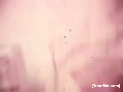 The 16mm still from the 'Borden American Cheese' commercial shows significant color fading, primarily to a red hue, characteristic of aged film stock. The image lacks clarity and detail, with visible imperfections such as scratches or dust, reflecting the deterioration common in old footage. Overall, the aesthetics suggest a nostalgic, vintage look typical of early 1970s commercials.