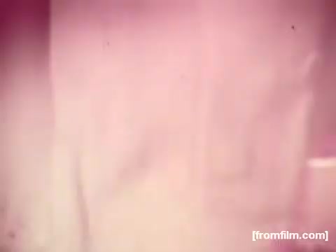 The still from the 'Borden American Cheese' commercial shows significant color fading, primarily to reddish tones, typical of early 1970s film deterioration. The image lacks clarity and vibrancy, with only hints of yellow remaining. The overall effect gives it a nostalgic and vintage look, characteristic of aged archival footage.