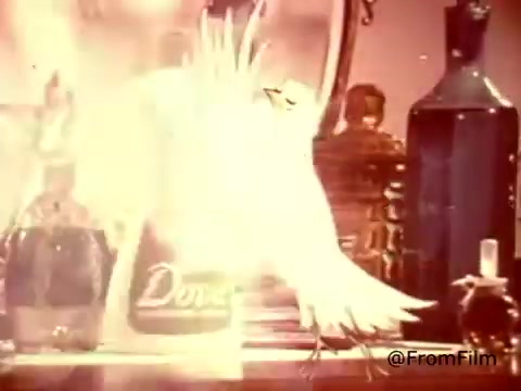 In this 16mm still from a 1970s Dove dishwashing detergent commercial, a cartoonish dove gracefully takes center stage, likely symbolizing purity and gentleness. The backdrop features a cluttered kitchen countertop with various household items, emphasizing a homey atmosphere. The tagline, 'Stand back, madam - Dove is the dishwashing detergent that thinks it's a hand lotion!' suggests a playful contrast between traditional dishwashing products and Dove’s gentler formulation. The visual style captures the warm, nostalgic aesthetic of the era, appealing to family-centric viewers.    for more nostalgic content!