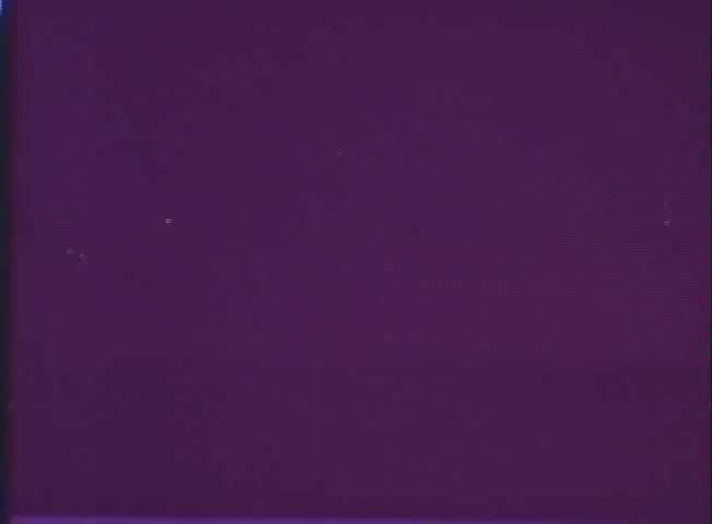 The still from the trailer for 'One Day in the Life of Ivan Denisovich' features a purplish background, indicative of the faded quality typical of a 16mm print. The film, based on Alexander Solzhenitsyn's novel, explores themes of survival and humanity in a Soviet labor camp, with Tom Courtenay portraying the protagonist. The simplicity of the still suggests a focus on the stark emotional and psychological landscape represented in the film.