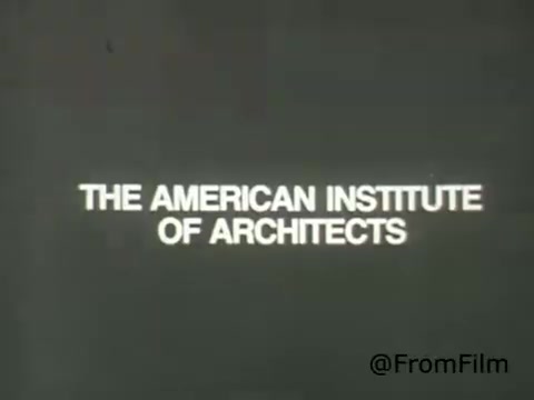 The still features a simple, bold text design that reads 'THE AMERICAN INSTITUTE OF ARCHITECTS.' The background is likely a muted color, emphasizing the clarity and impact of the white text. This image is from a public service announcement (PSA) produced in 1969, aiming to promote the mission and importance of the American Institute of Architects. The design reflects the visual styles common in that era, focusing on straightforward communication.