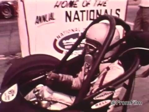 The still features Don Garlits, a prominent drag racer, seated in a drag racing vehicle, with a sign indicating the event as the 'Home of the Annual Nationals.' The context suggests it's focused on the importance of car maintenance for competitive drag racing. The Dodge in question is likely from the 1960s, possibly around 1965-1969, given the era of Garlits' prominence in the NHRA. The vehicle appears to be a specialized dragster rather than a typical Dodge model.