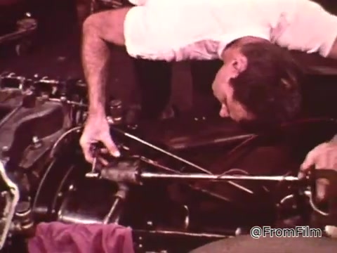 The still from 'Dragsters and Cars,' featuring Don Garlits, showcases a scene where he's performing car maintenance, likely focusing on engine work. The background includes parts of the vehicle and tools, emphasizing the technical aspects of drag racing preparation.   As for the Dodge in the video, it's difficult to pinpoint the exact year without more context, but Dodge vehicles from the 1960s, especially models like the Coronet or Dart, are often associated with drag racing from that era. If you provide specific details about the car, it might help narrow it down further.