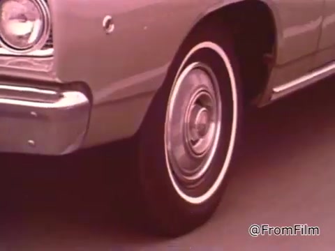 The still appears to show a classic Dodge vehicle, likely from the mid to late 1960s, based on the design elements. Dodge models from this era, such as the Dart or Coronet, were popular in drag racing circles. The specific year may be identified more accurately by looking at other features like the grille or tail lights.